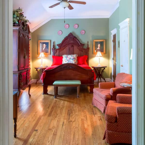 Classic wooden arched door leading to a room with a checkerboard patterned floor.